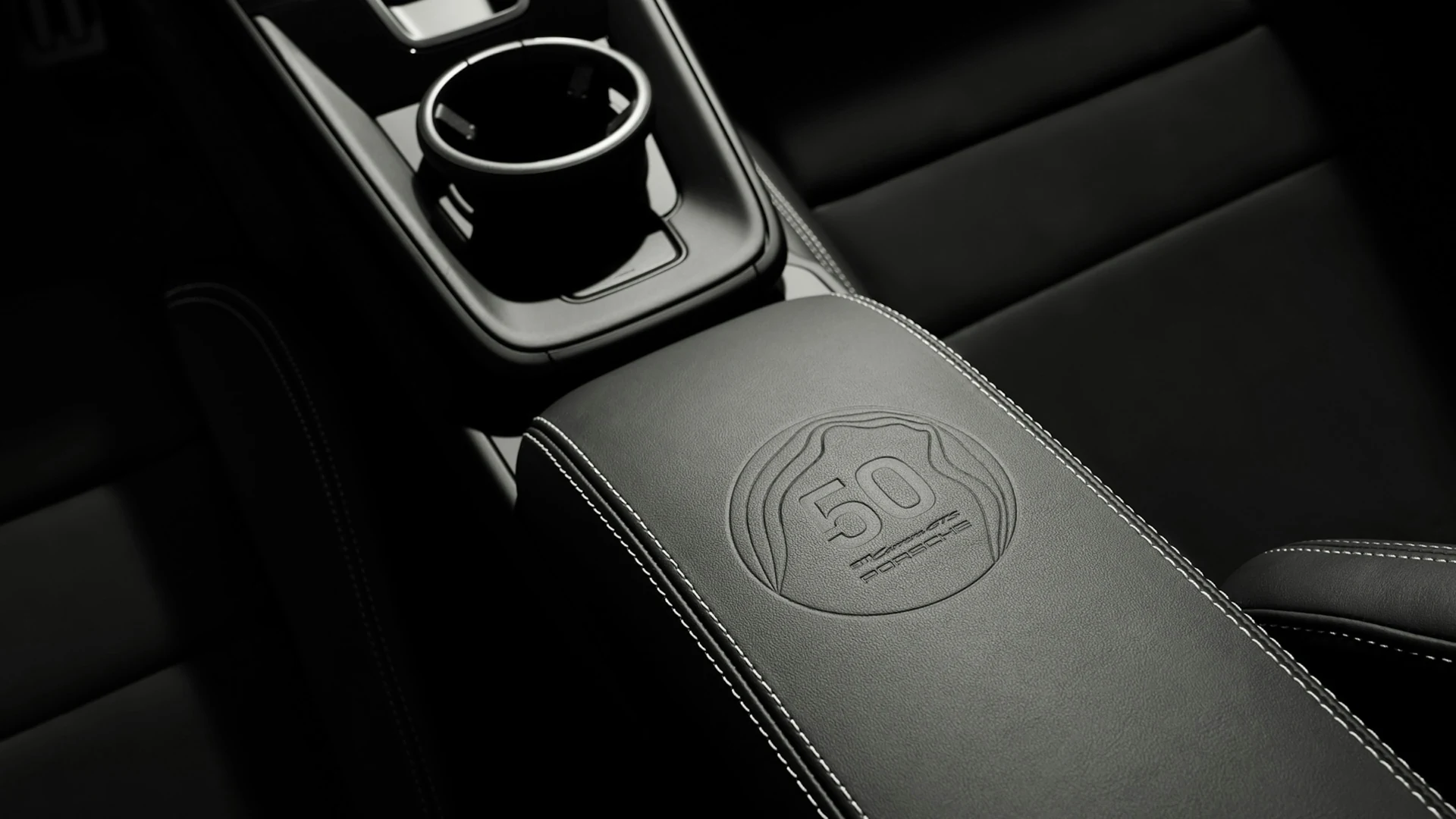 Black leather armrest with an embossed 50-year anniversary emblem