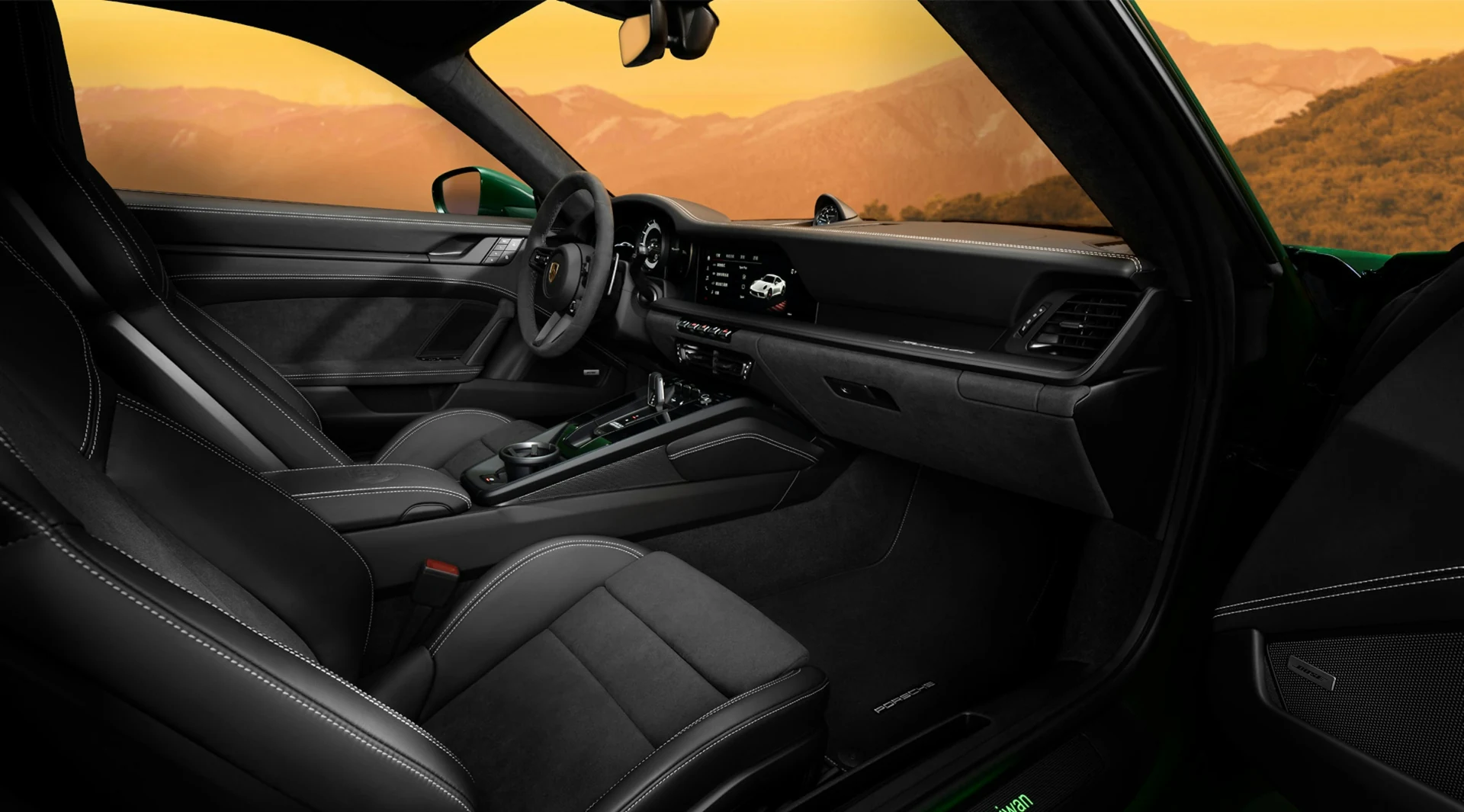 Black leather cockpit with warm mountain scenery beyond the windows