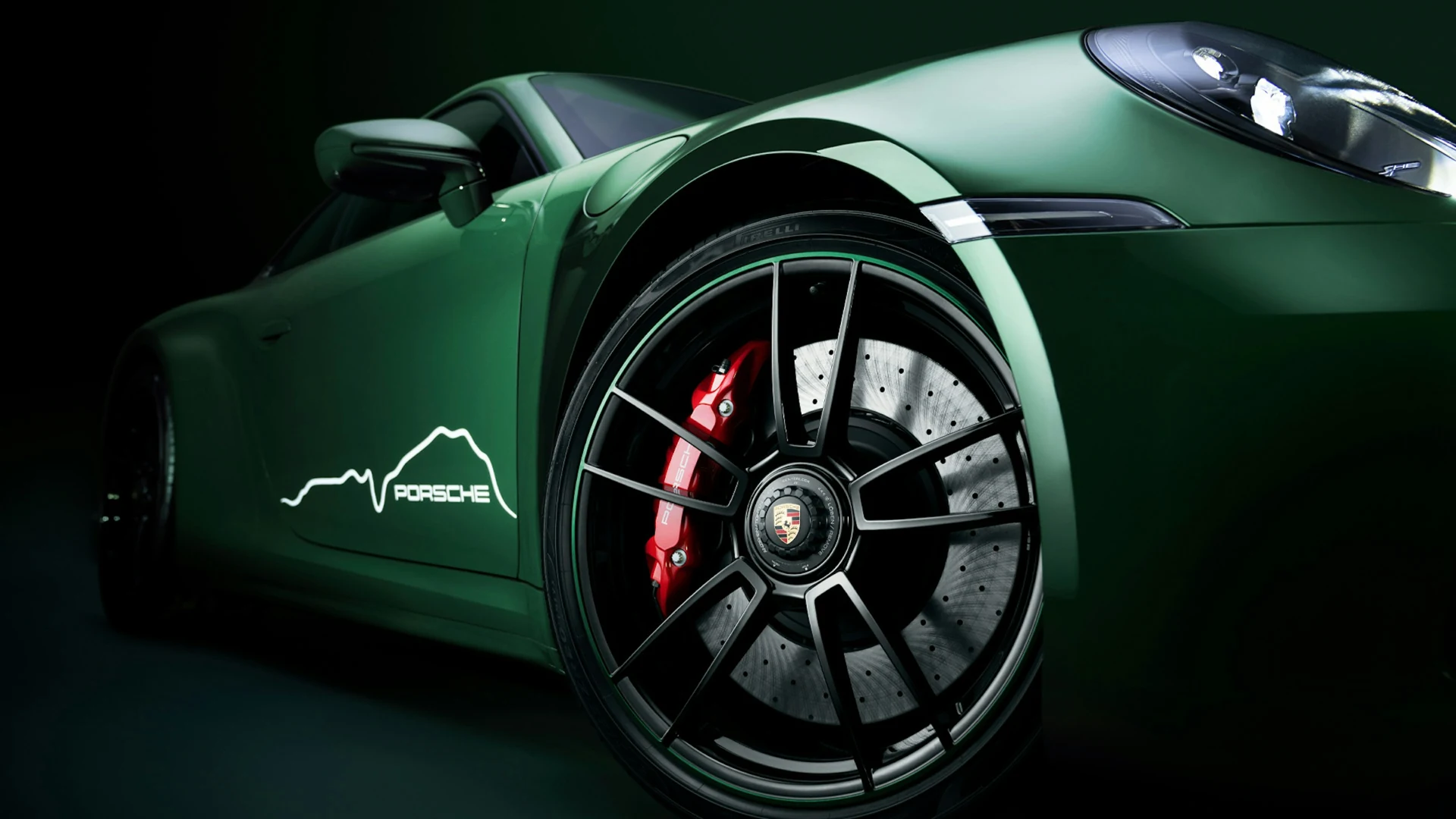 Polished silver wheel spokes, black tyre and red brake caliper